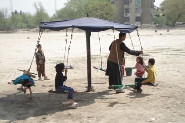 Children on a merry-go-round in Kabul, a memory image connected to Atta's mission.